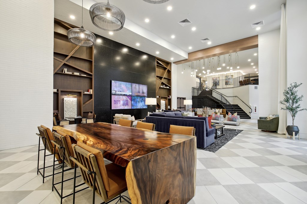 the lobby of a hotel with a large table and chairs