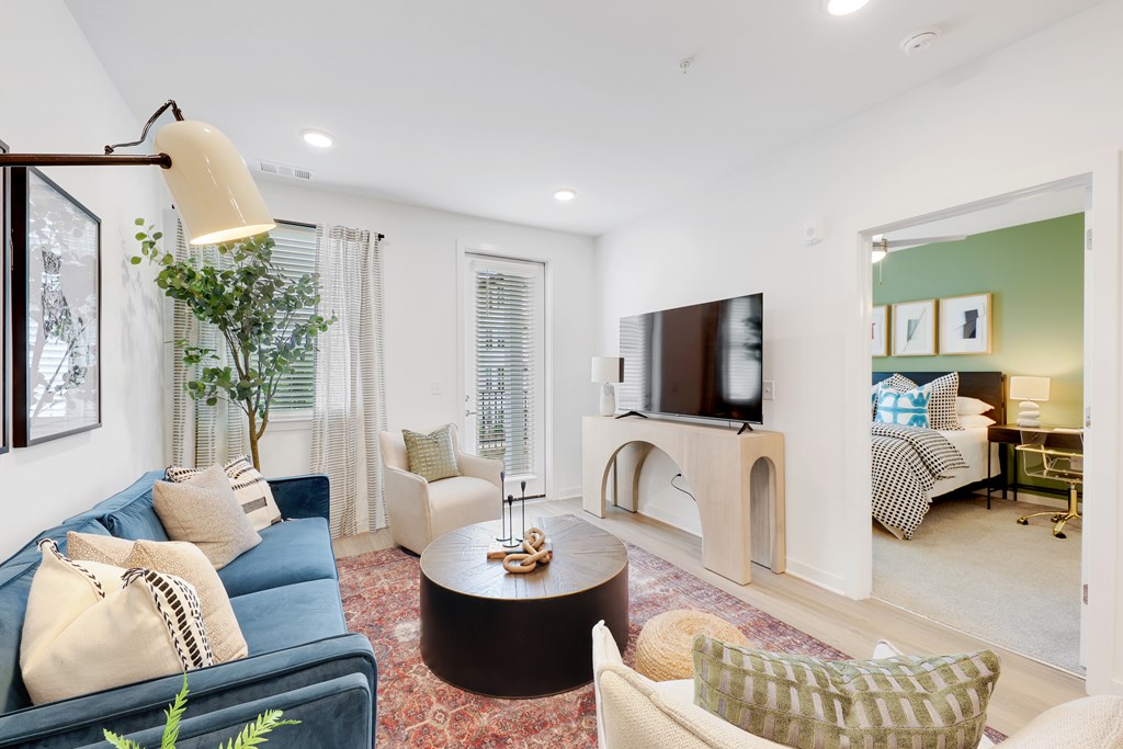 a living room with a blue couch and a fireplace