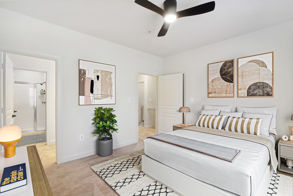 a bedroom with a bed and a ceiling fan