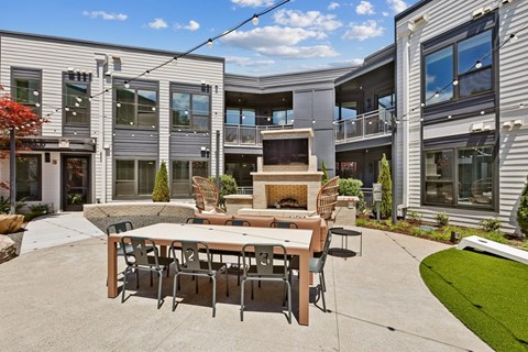 A modern outdoor dining area with a table set for six.