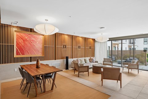 A modern dining room with a wooden table and chairs.