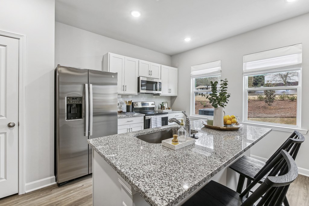 a kitchen with granite counter tops and stainless steel appliances