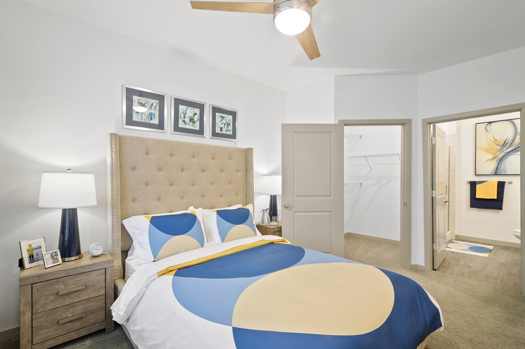 a bedroom with a bed and a door to a bathroom