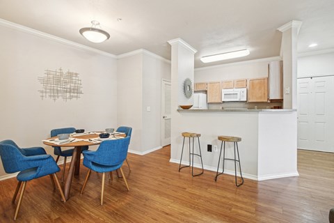 a dining room with a table and chairs and a kitchen