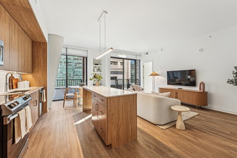 A modern kitchen with wooden cabinets and a white countertop.
