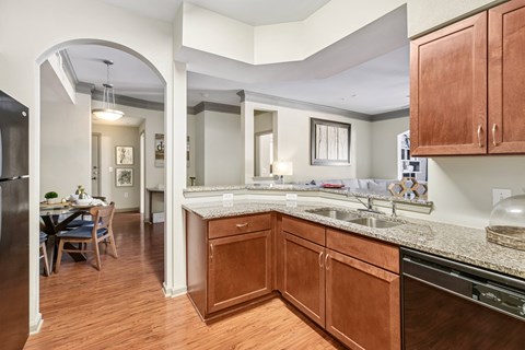 A kitchen with wooden cabinets and a refrigerator.