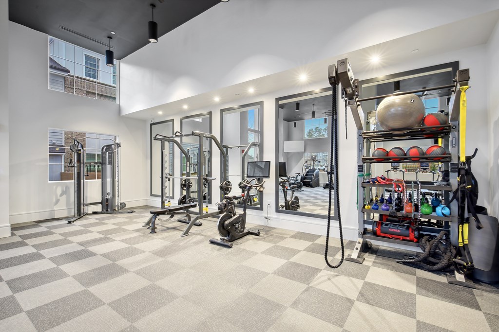 a gym with weights and other exercise equipment in the corner of a room