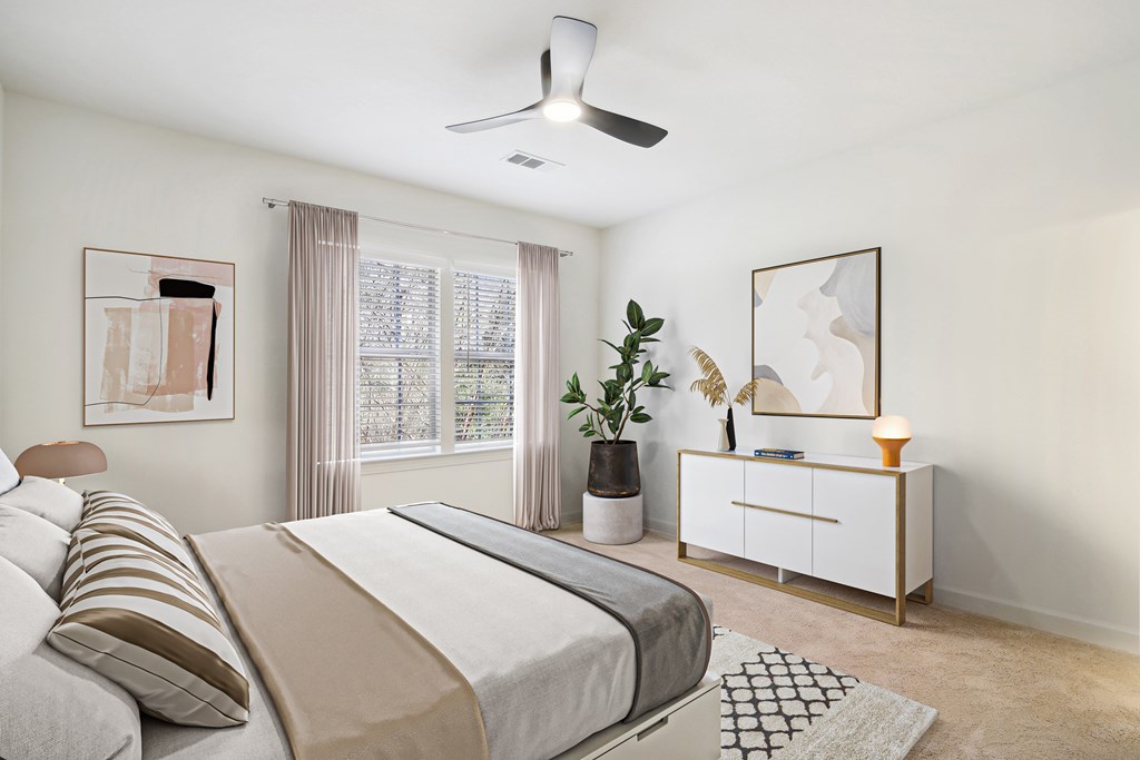 a bedroom with a bed and a ceiling fan