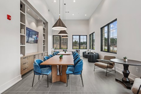 A modern dining room with a large table and chairs.
