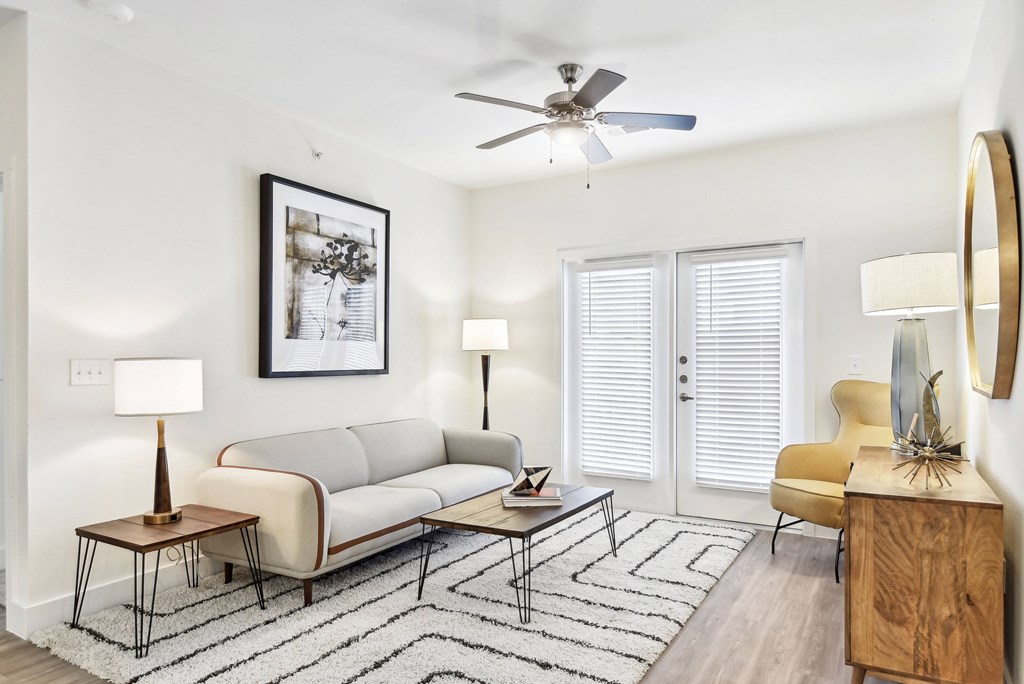 a living room with a couch and a ceiling fan
