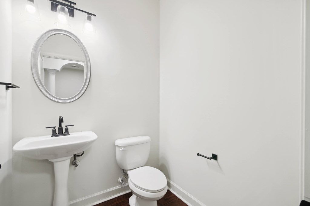 a bathroom with a toilet and a sink and a mirror