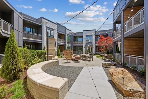 A courtyard with a circular walkway and a seating area in the middle.