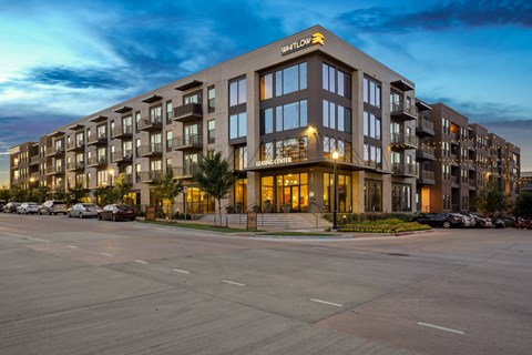 A large apartment complex called Whitlow is shown at dusk.