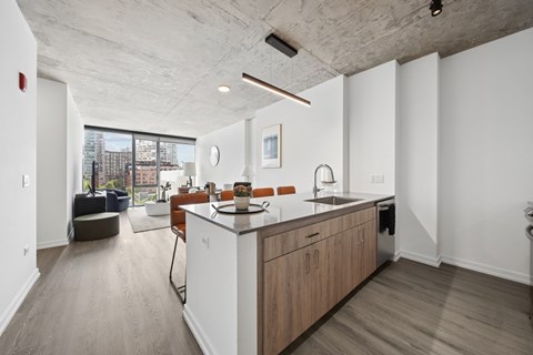 A modern kitchen with wooden cabinets and a large island.