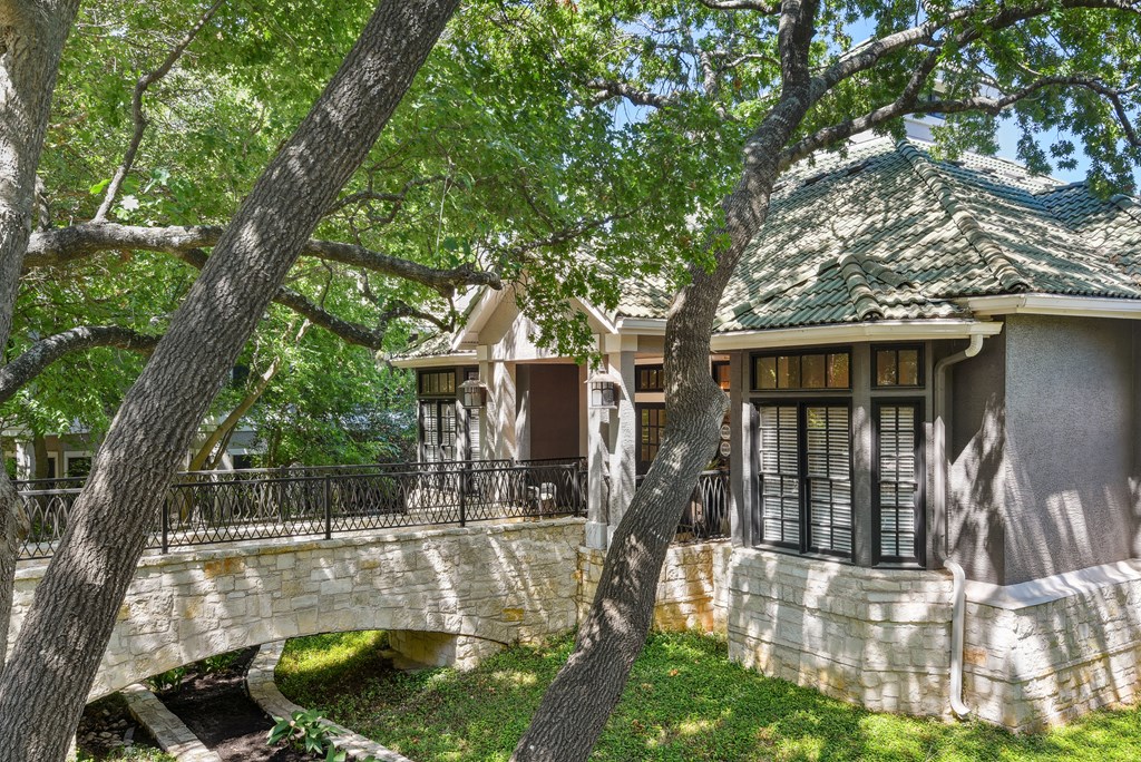 a house with a stone bridge in front of it