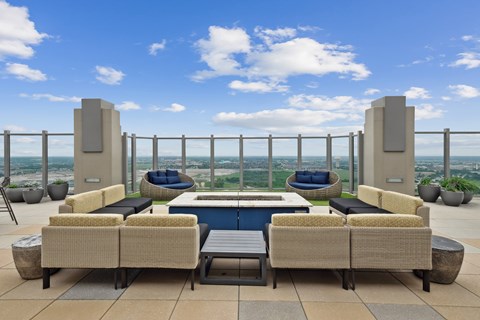 A patio with a pool and a view of the city.