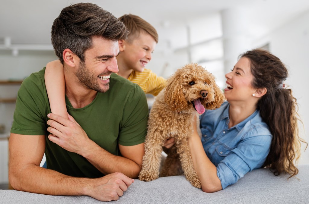 a group of people with a dog on a couch