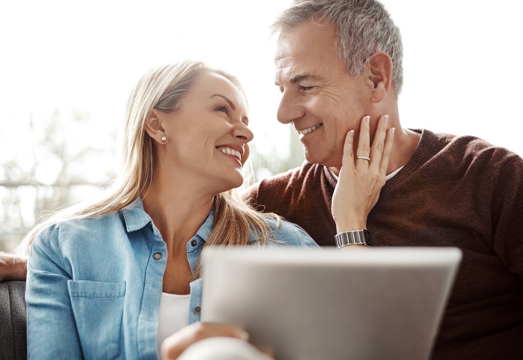 a man and a woman looking at a laptop computer