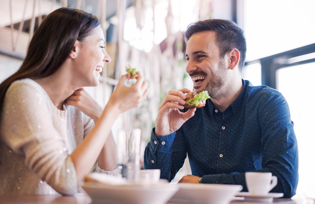 couple eating food at a table in a restaurant