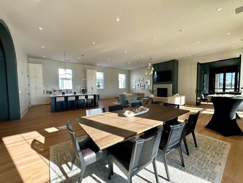 A modern dining room with a large table and chairs.