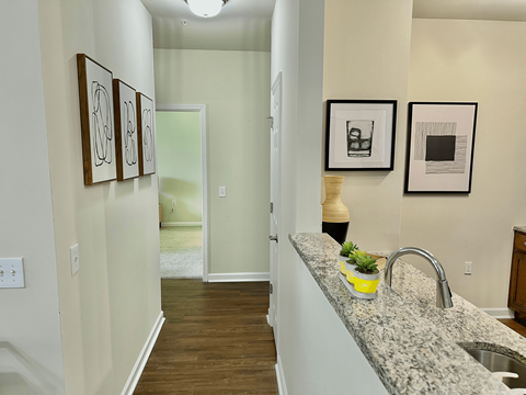 A kitchen with a granite counter top and a sink.