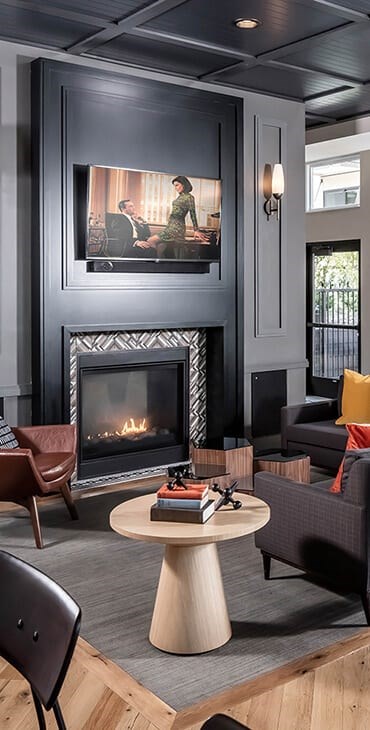 a living room with a fireplace and a painting on the wall