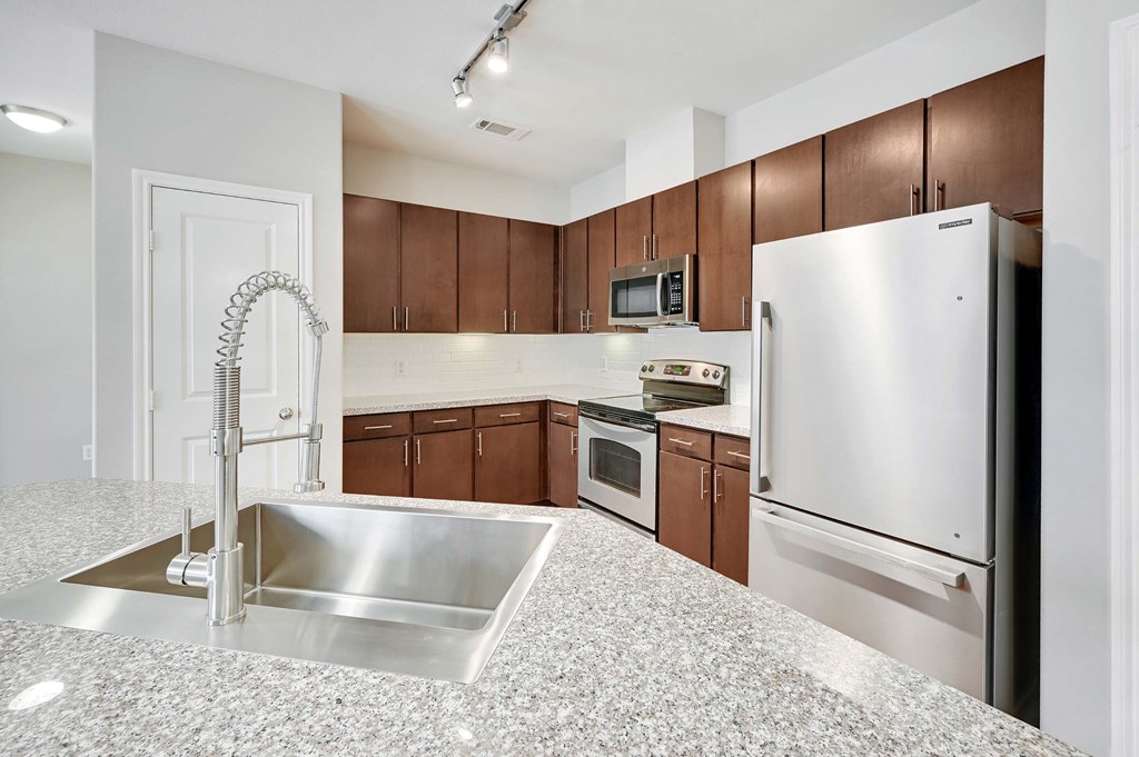 a kitchen with stainless steel appliances and granite counter tops