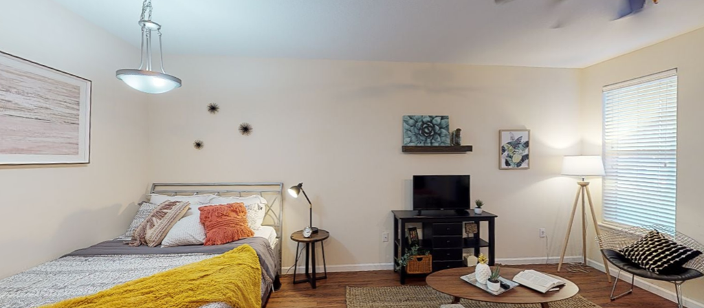 a bedroom with a bed and a tv