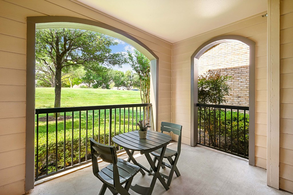 a patio with a table and chairs on a balcony