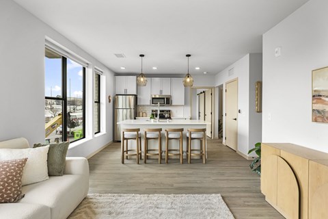 A modern kitchen with a dining table and chairs.