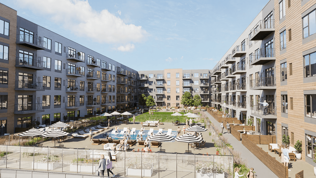 A sunny day at a modern apartment complex with people walking and lounging in the courtyard.