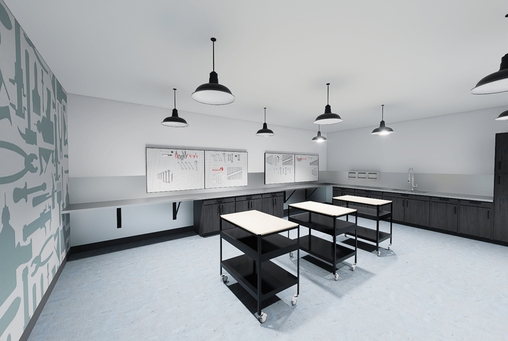 A classroom with a whiteboard and several tables.