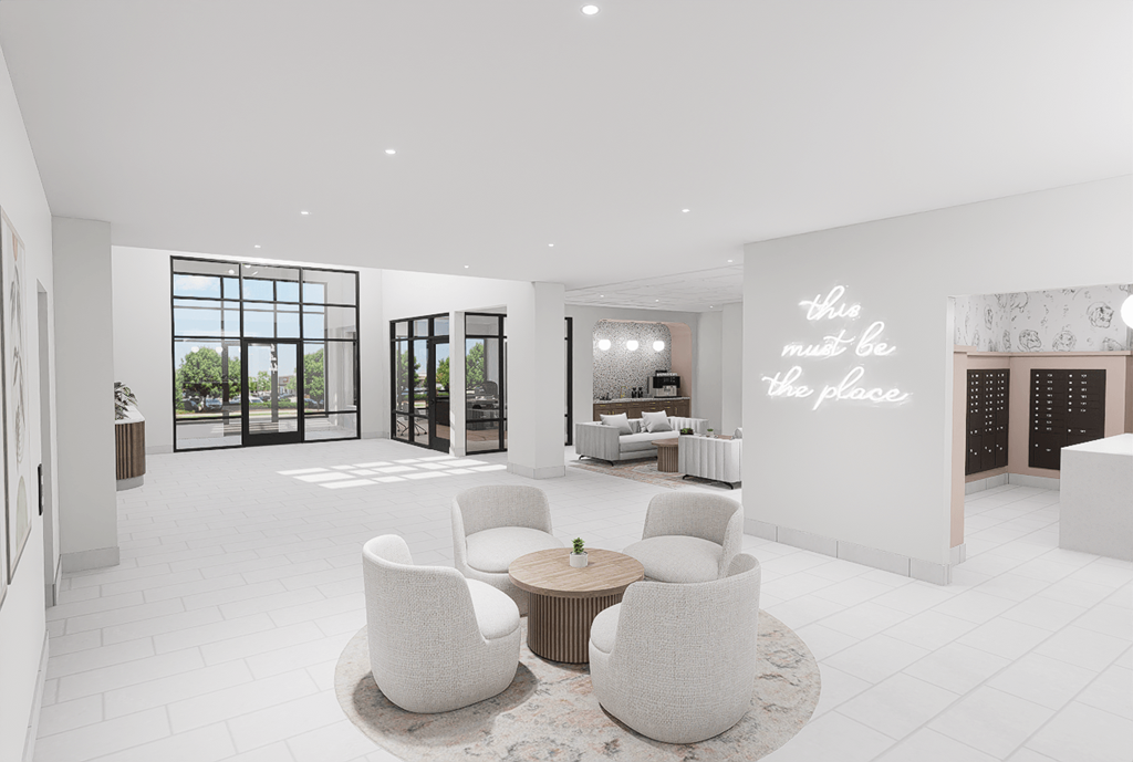 A white room with a table and chairs and a wall with the words "this must be the place".