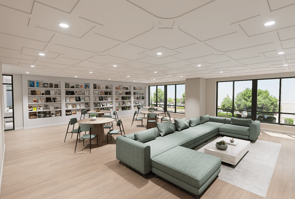 A modern living room with a green sofa set and a bookshelf filled with books.