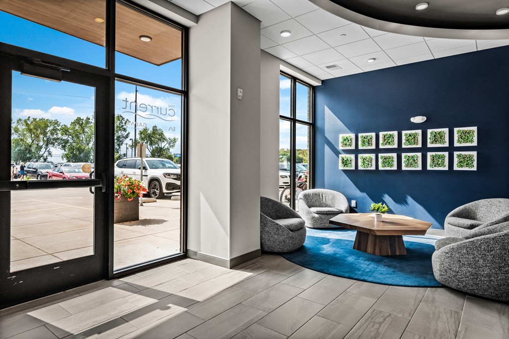 a lobby with couches and chairs and a table