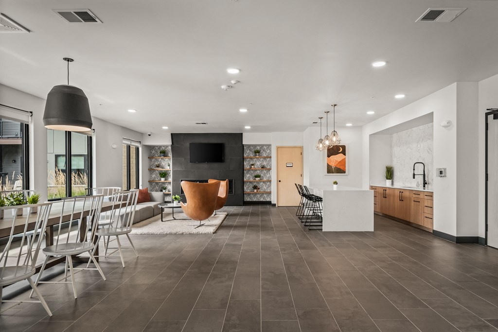 a living room and dining room with a table and chairs