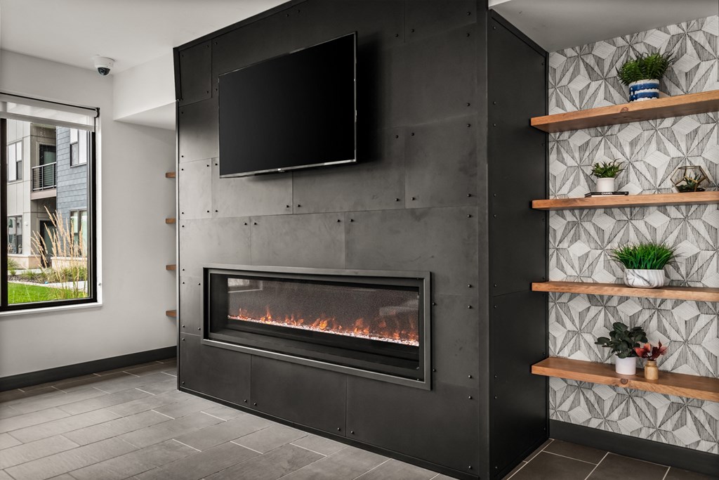 a living room with a fireplace and a tv on the wall