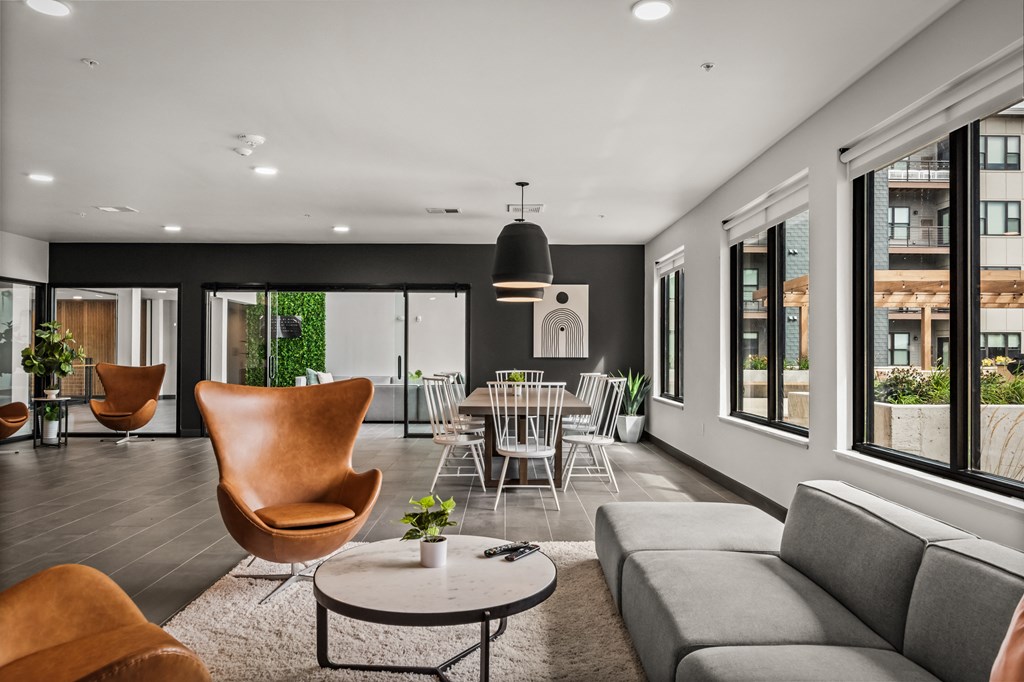 a living room with a couch and a table and chairs