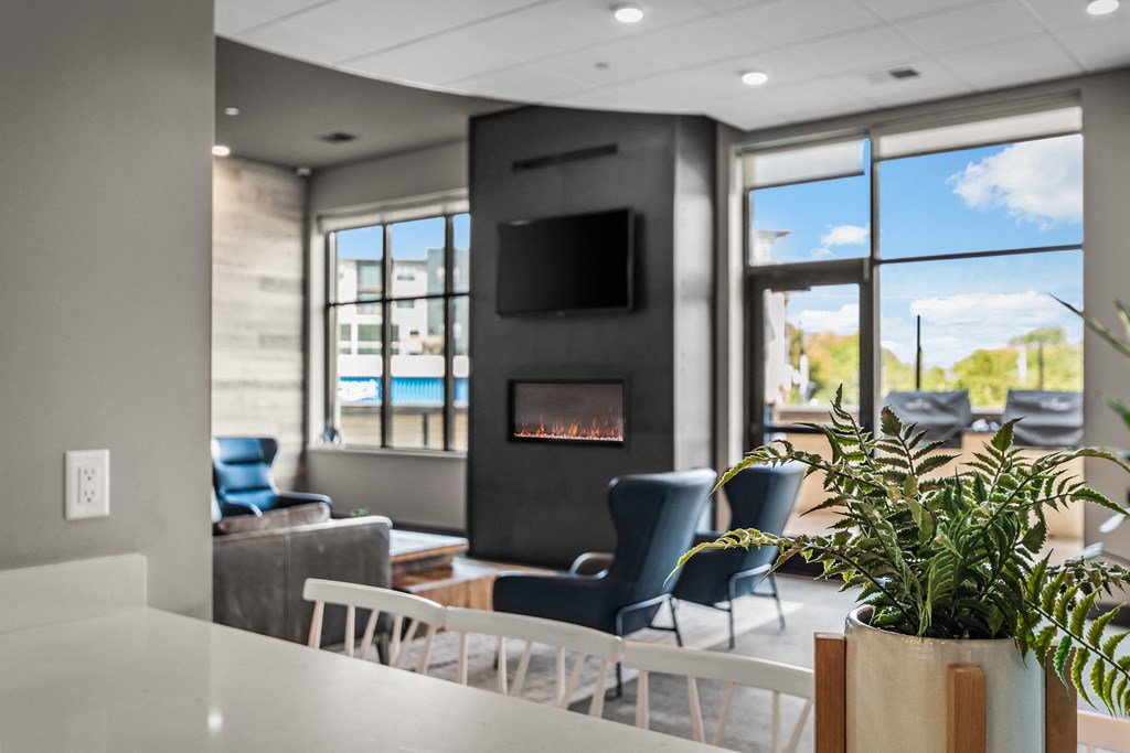 a living room with a table and chairs and a fireplace