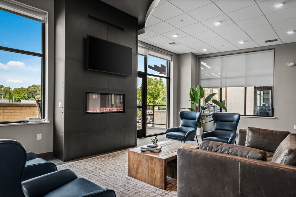 a living room with a couch and chairs and a fireplace