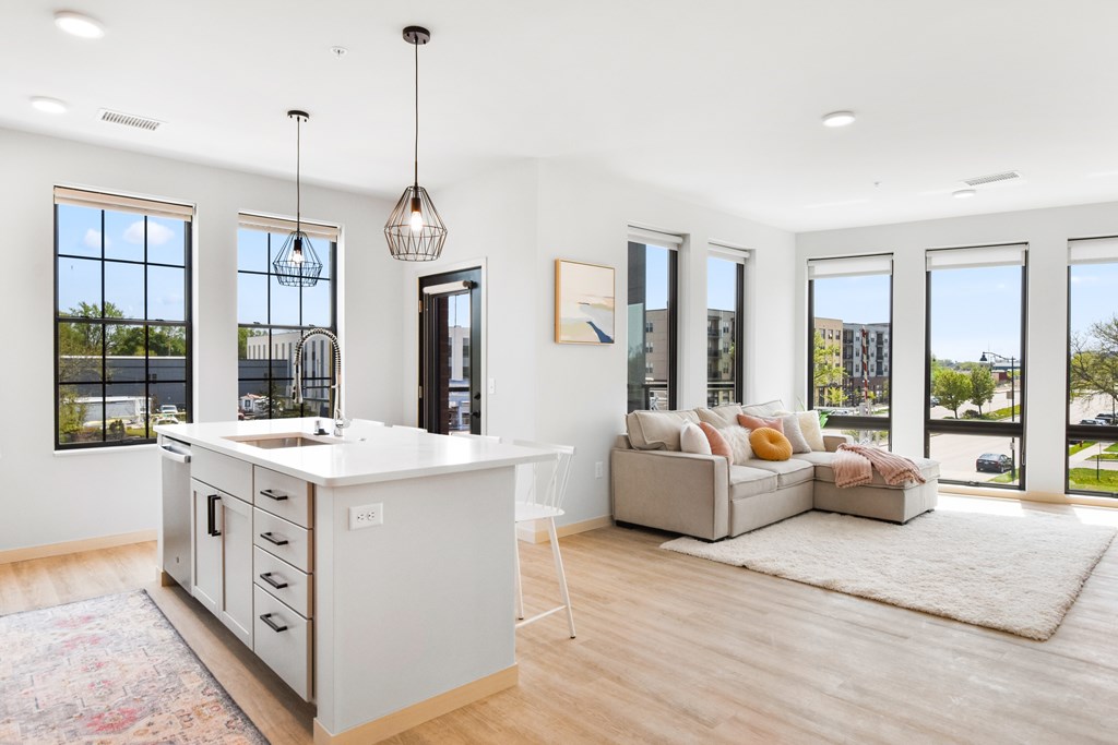 A modern kitchen with a large island and a view of the city.