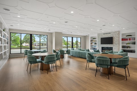 A modern living room with a large table and chairs.