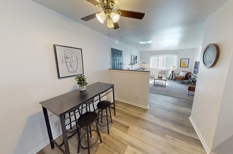A dining room with a table and chairs.