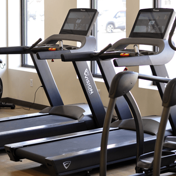 A row of treadmills are lined up in a gym at Riverhouse Apartments, Fargo, North Dakota 58102