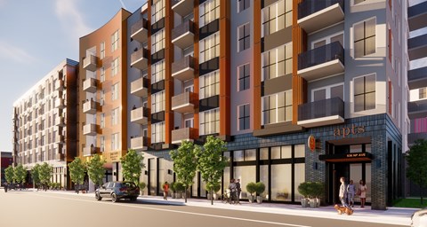A modern apartment building with a car parked in front.