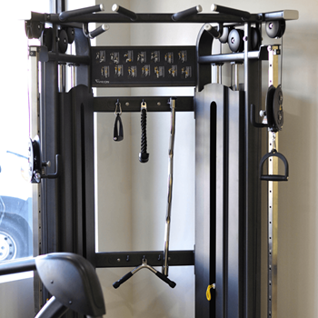 A black weight machine with a grey seat in front of a window at Riverhouse Apartments, Fargo, North Dakota 58102