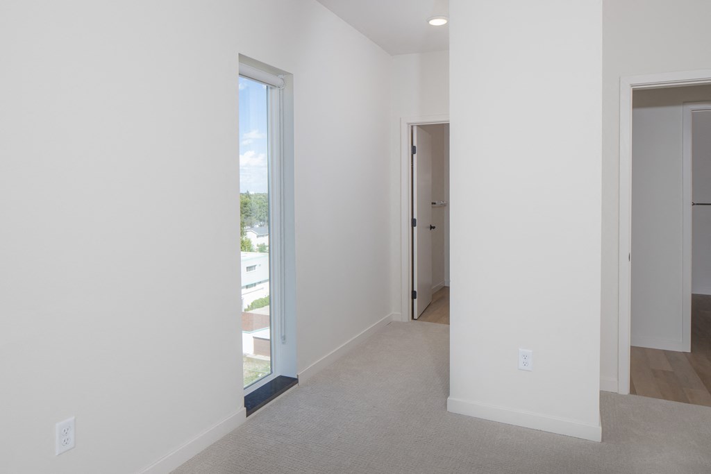 an empty room with a door to a hallway and a closet at Riverhouse Apartments, Fargo, North Dakota 58102