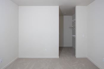 an empty room with white walls and a closet at Riverhouse Apartments, Fargo