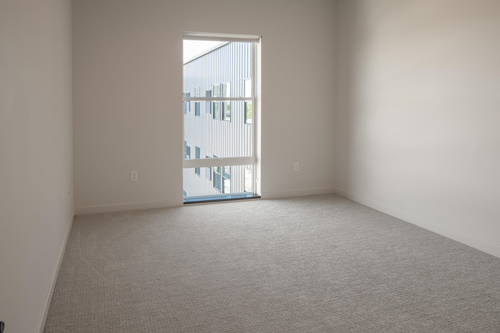 an empty room with a door to a balcony at Riverhouse Apartments, Fargo