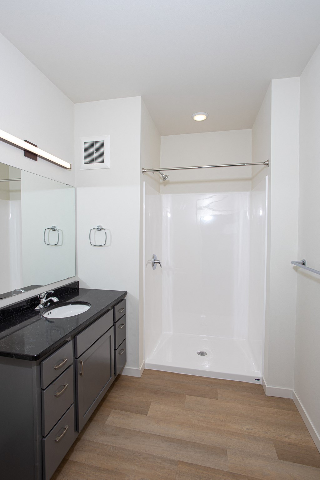 a small bathroom with a sink and a shower at Riverhouse Apartments, Fargo, ND 58102